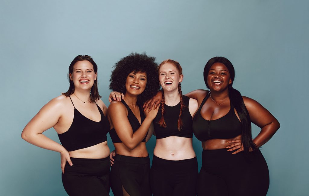 Group of four diverse women in gym clothes. 