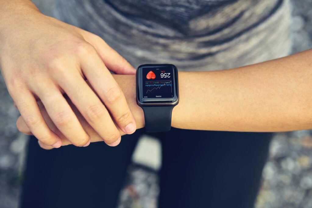 Woman checking her smartwatch device for her heart rate and other health metrics